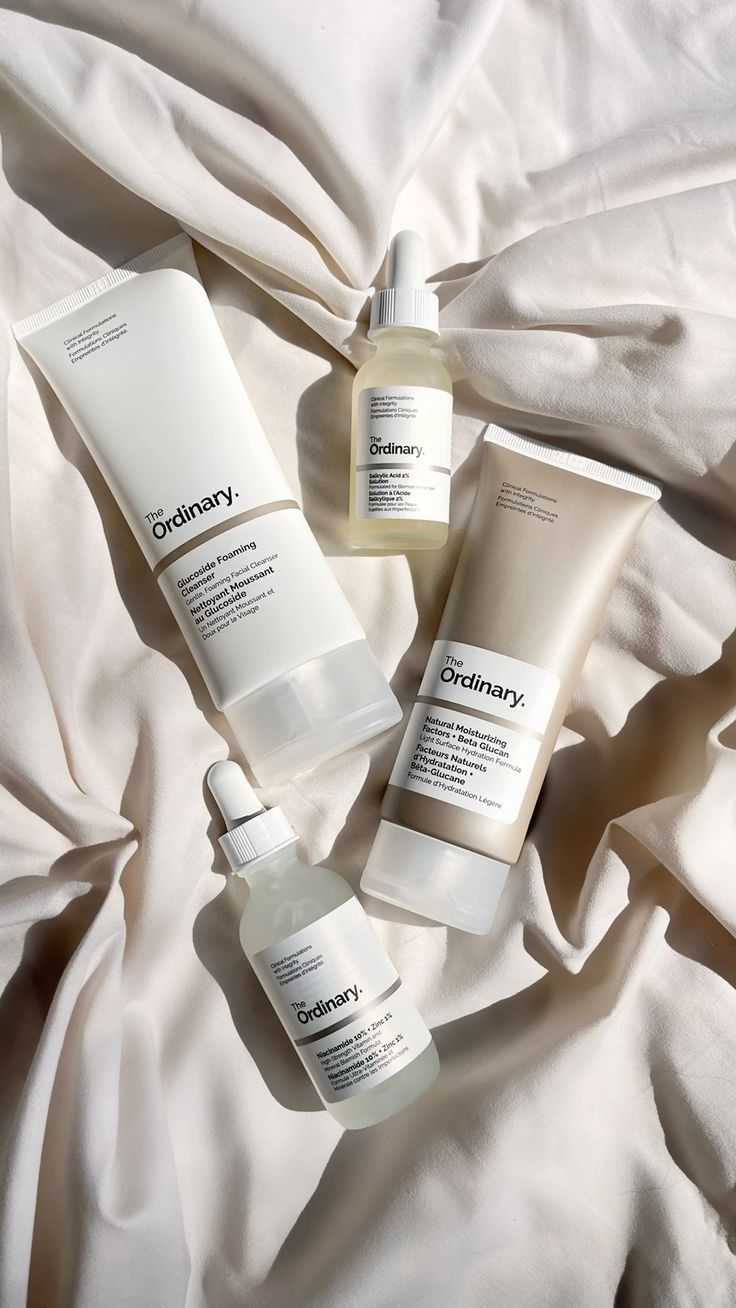 The Ordinary skincare products lineup on fabric background, featuring popular serums for glowing skin and effective face treatments.
