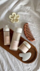 night skincare routine flat lay with products on wooden tray