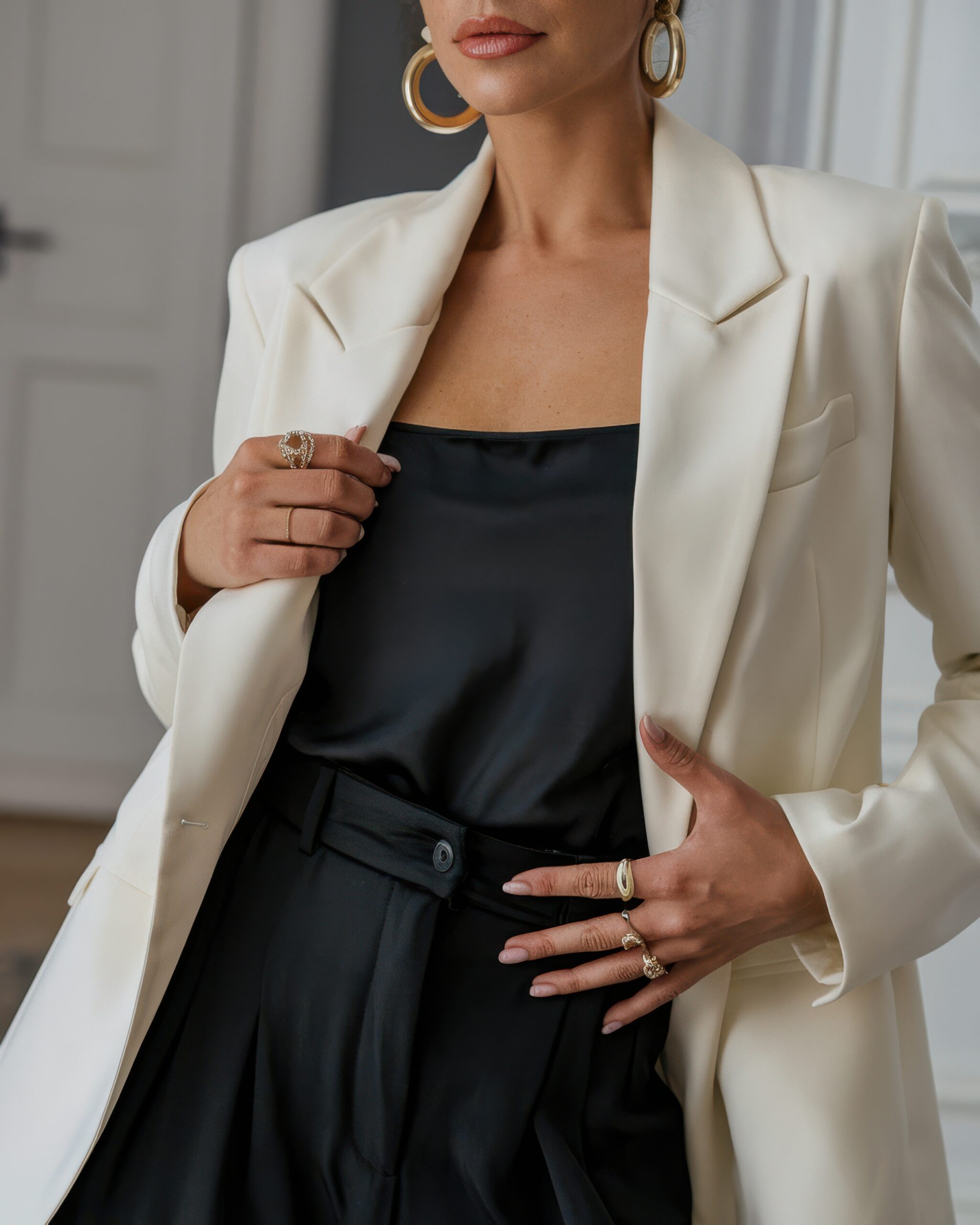 polished outfit with white blazer and gold accessories