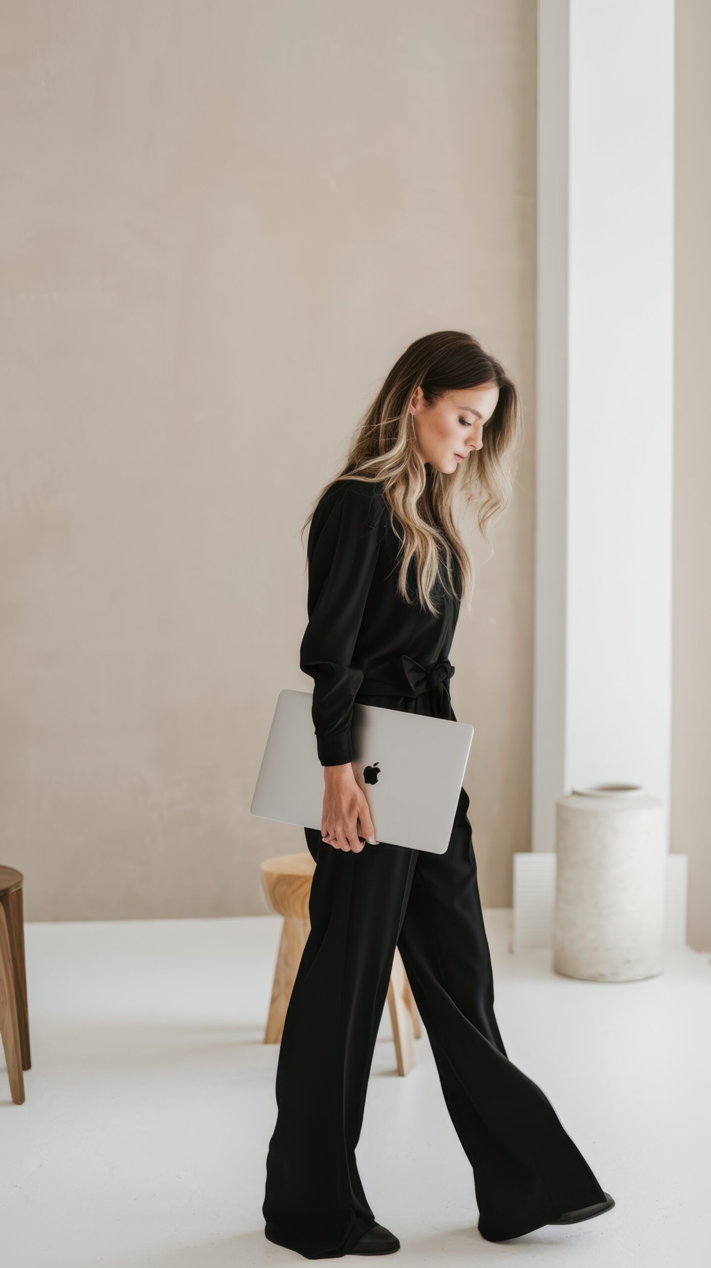 confident woman in all black outfit walking with good posture