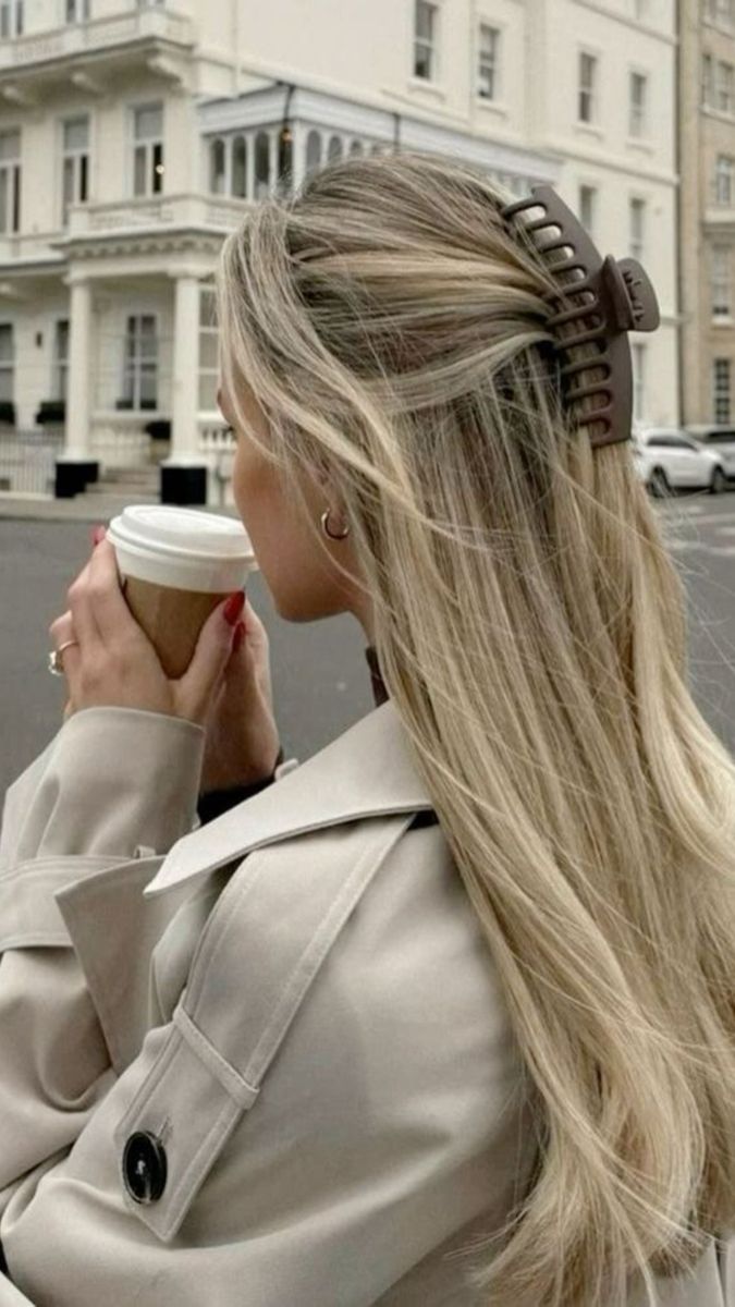 sleek blonde hair with claw clip and coffee