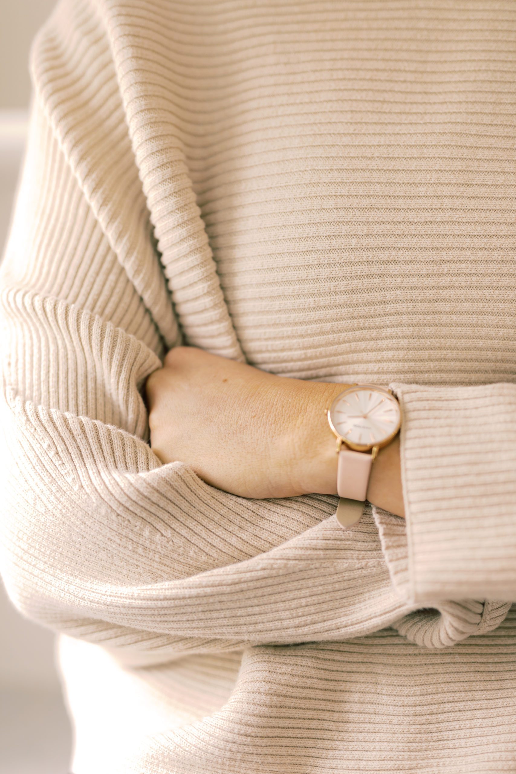wrist with watch in cozy sweater perfume pulse point