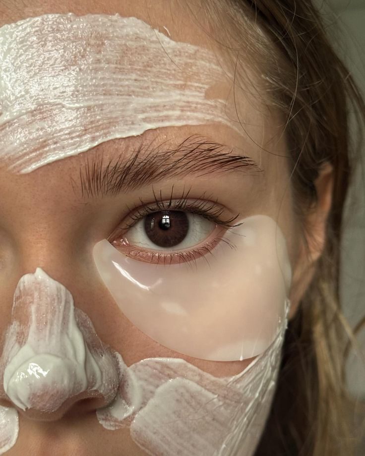 close-up of skincare routine with eye patches and cream