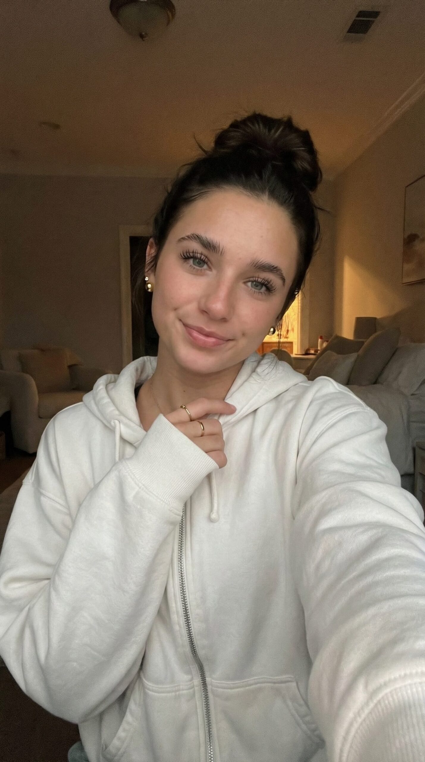 candid morning selfie woman with messy bun and natural skin skincare routine