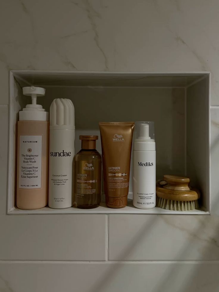 shower niche with body care products and dry brush