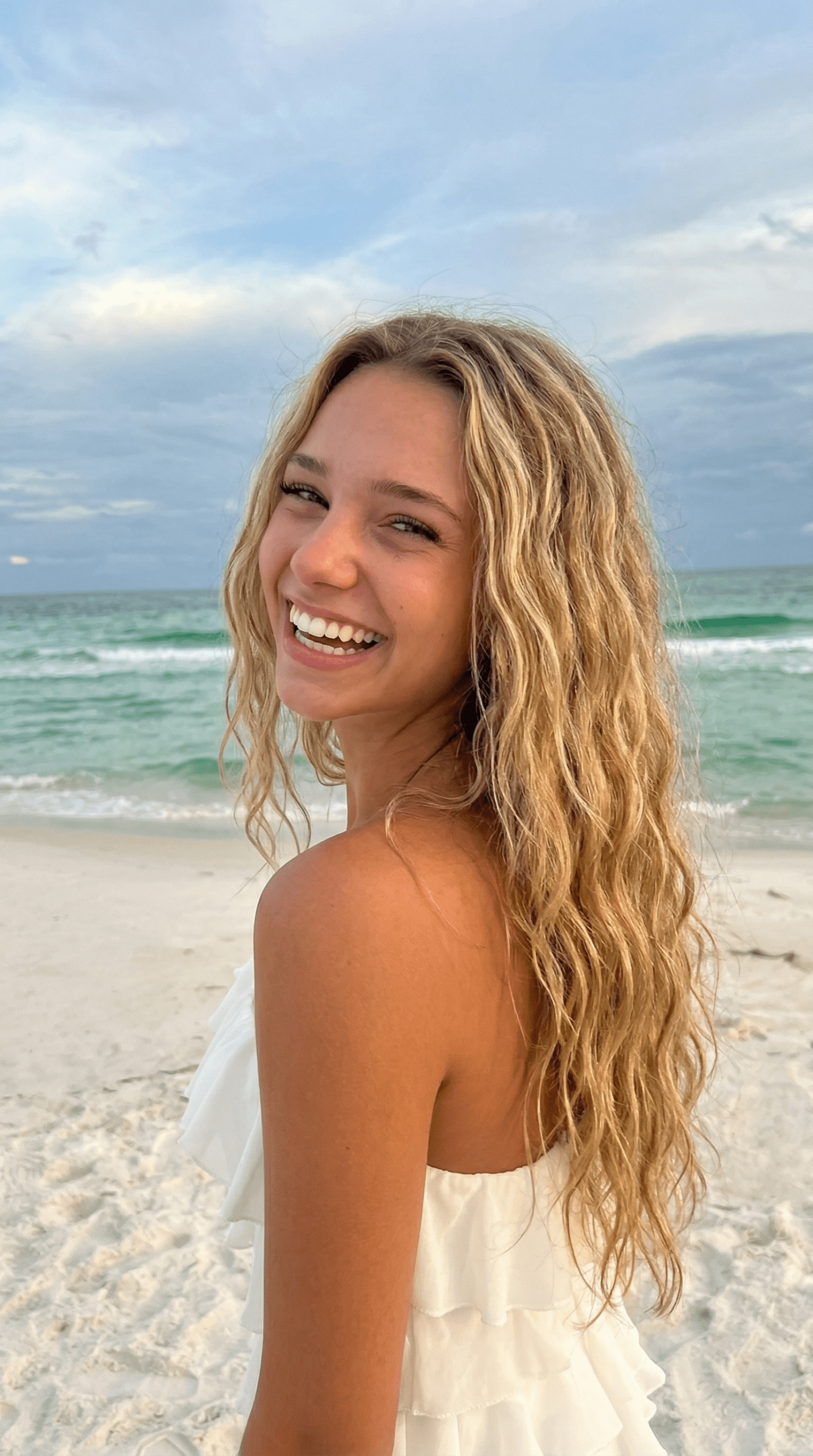 woman with natural wavy beach hair smiling
