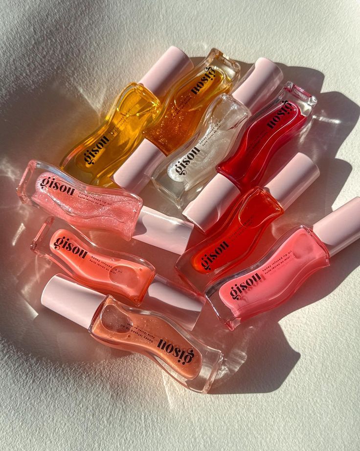 collection of glossy lip oils flat lay aesthetic