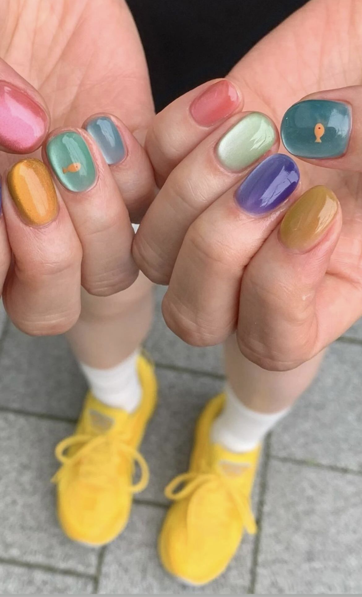 jelly mismatched manicure with a different pastel color on every short nail