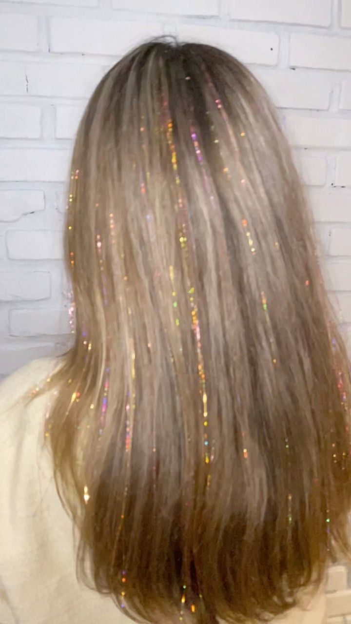 brunette hair with holographic hair tinsel along the part and crown