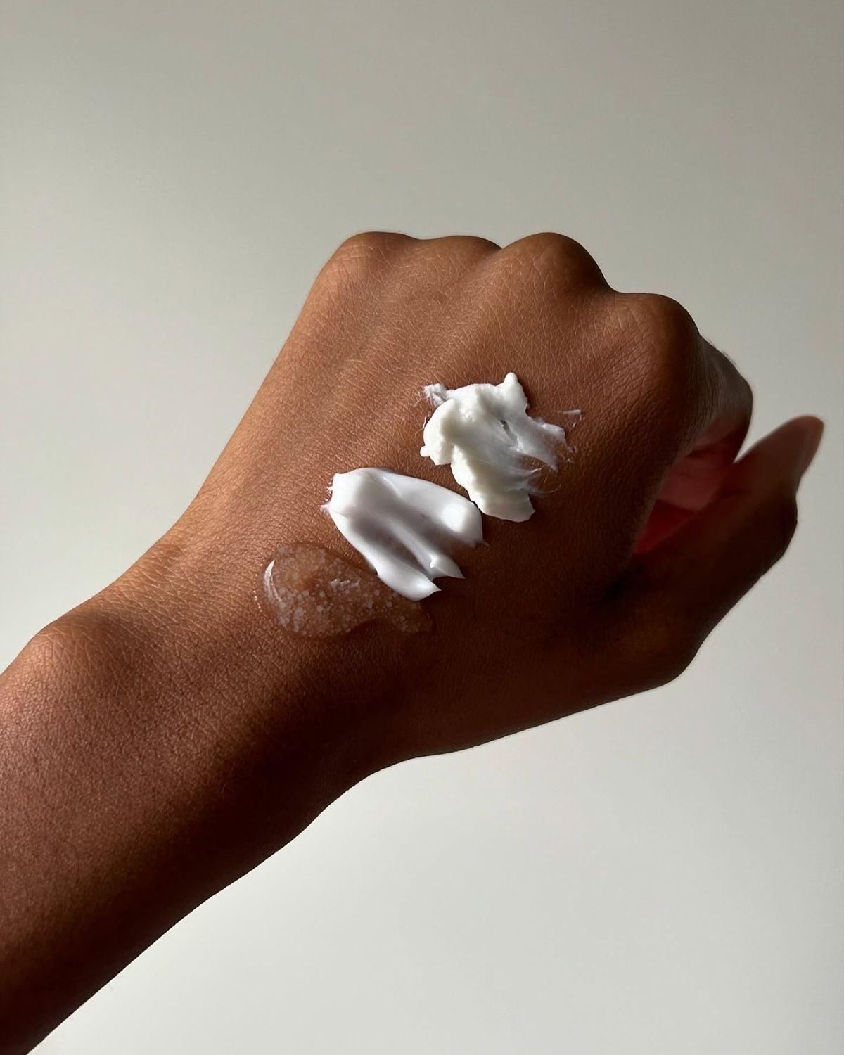 swatch of moisturizer cream on the back of a hand