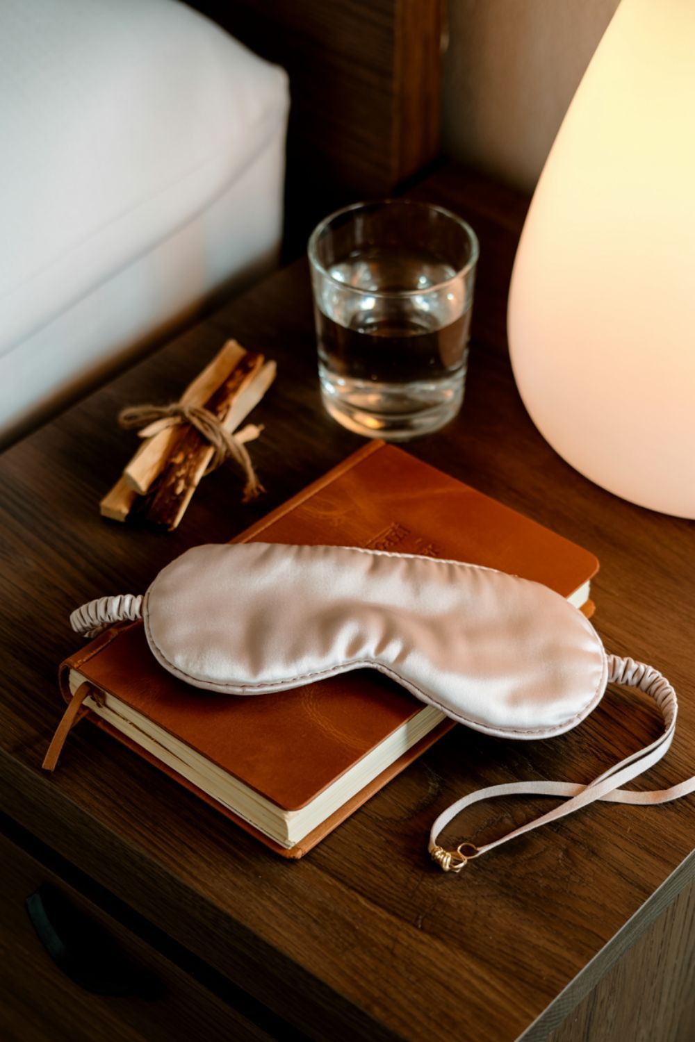 silk sleep mask and journal on a nightstand morning routine