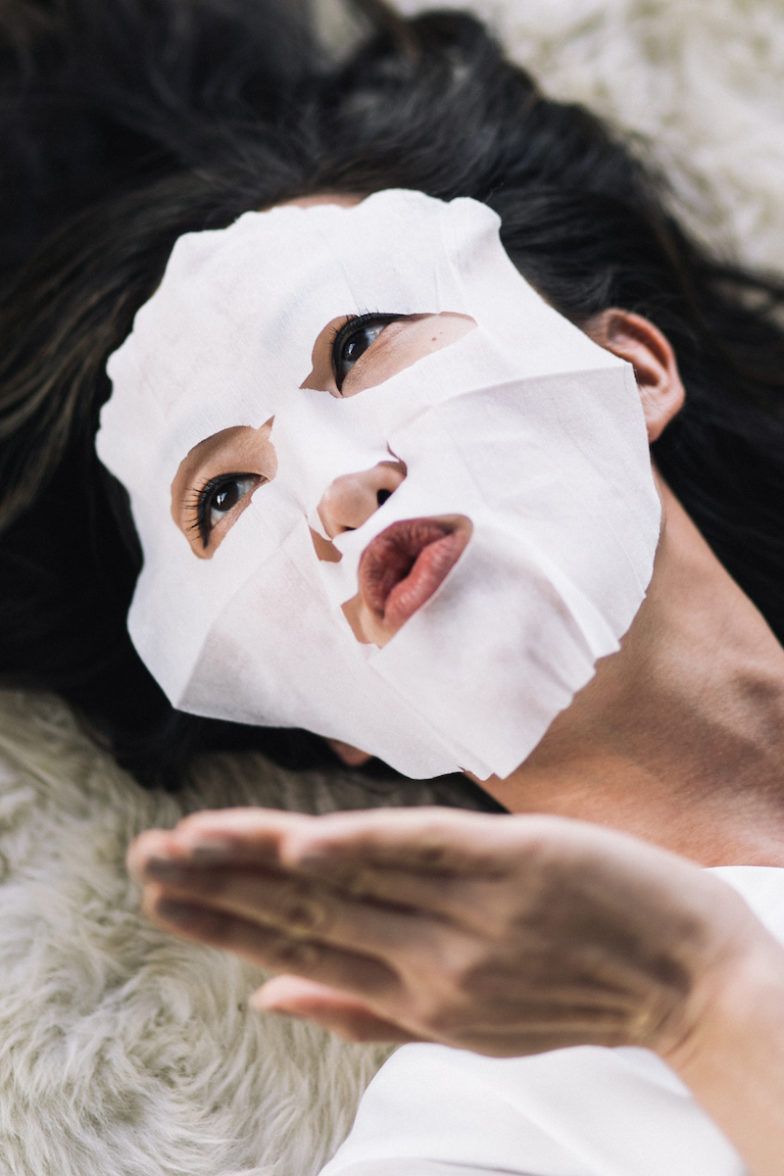 woman applying skincare serum