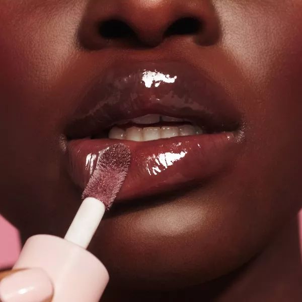 lip oil application closeup