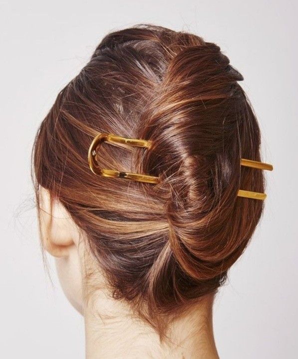 french twist updo held with two gold french pins