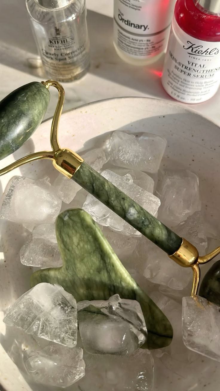 jade gua sha and facial roller flat lay