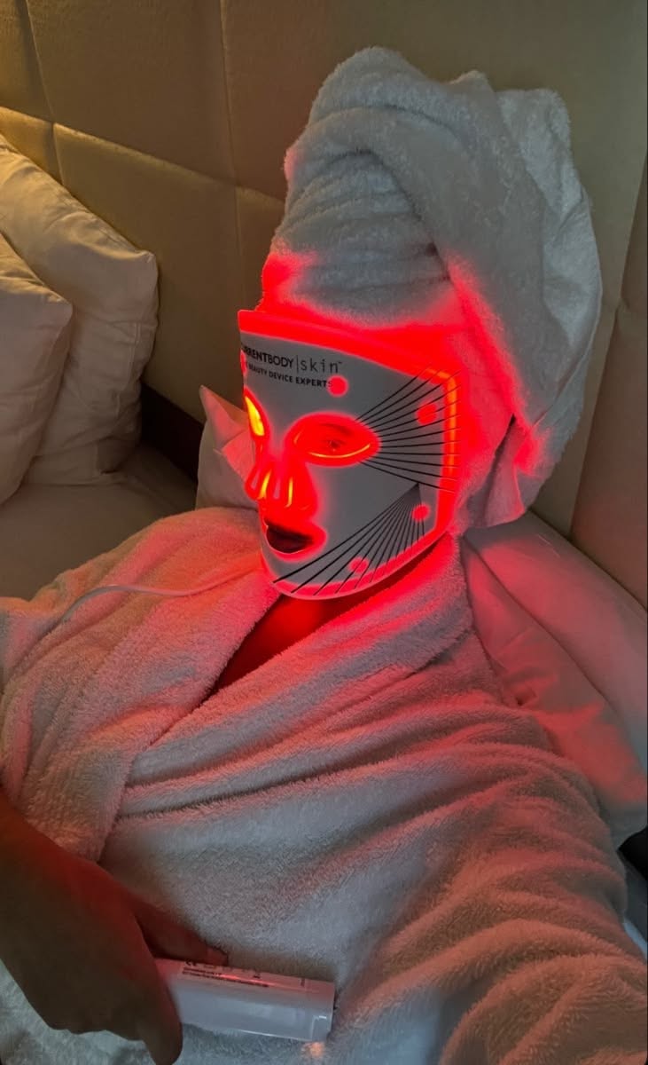 red light therapy mask selfie with hair in a towel