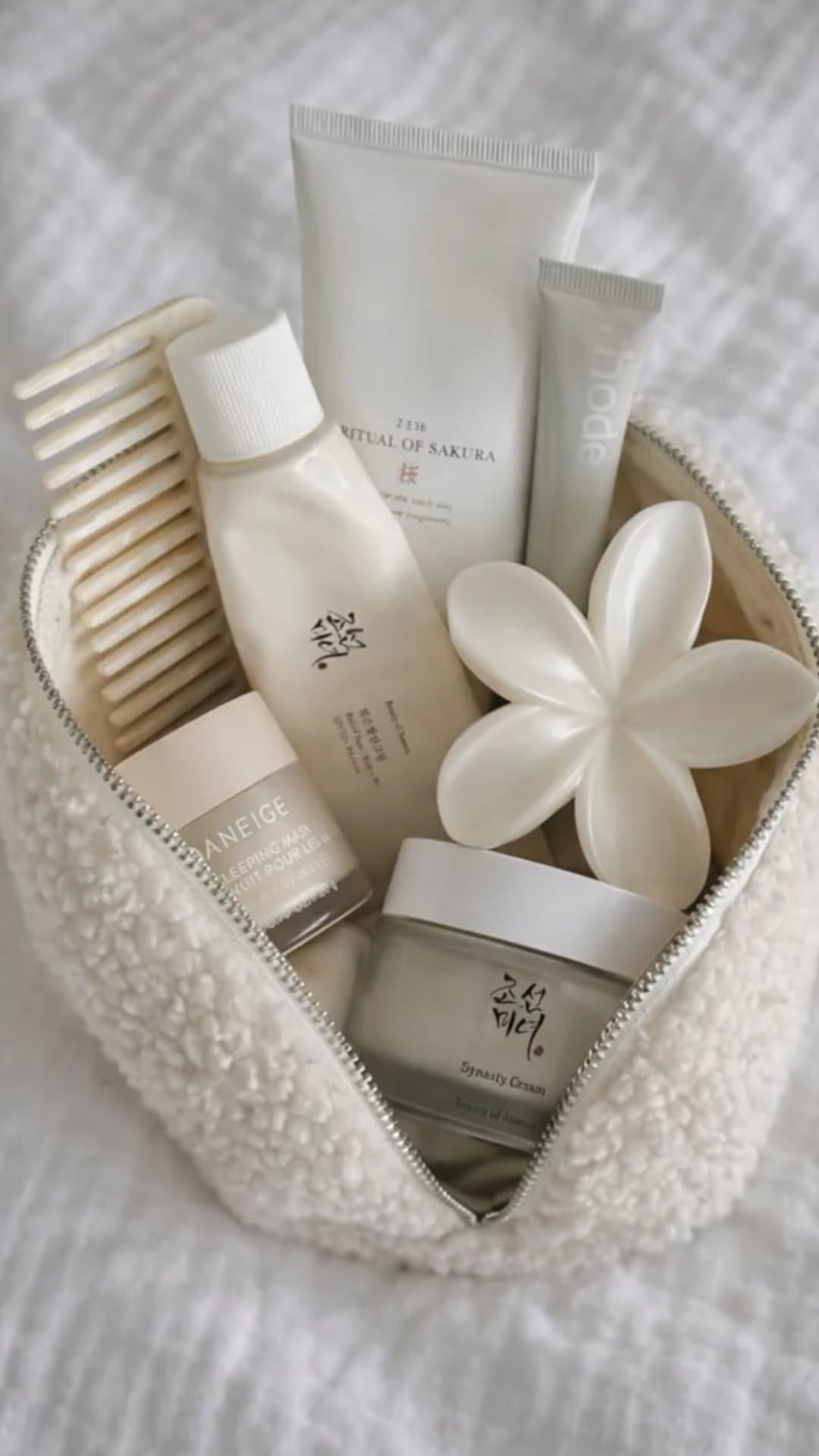 gentle skincare products in a soft pouch flat lay